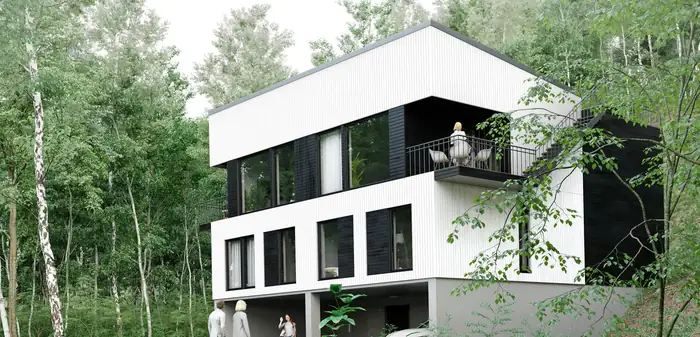 Hvitt hus med svart sokkel mellom trærne